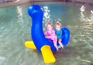 blue and yellow log roller in the pool for kids and adults